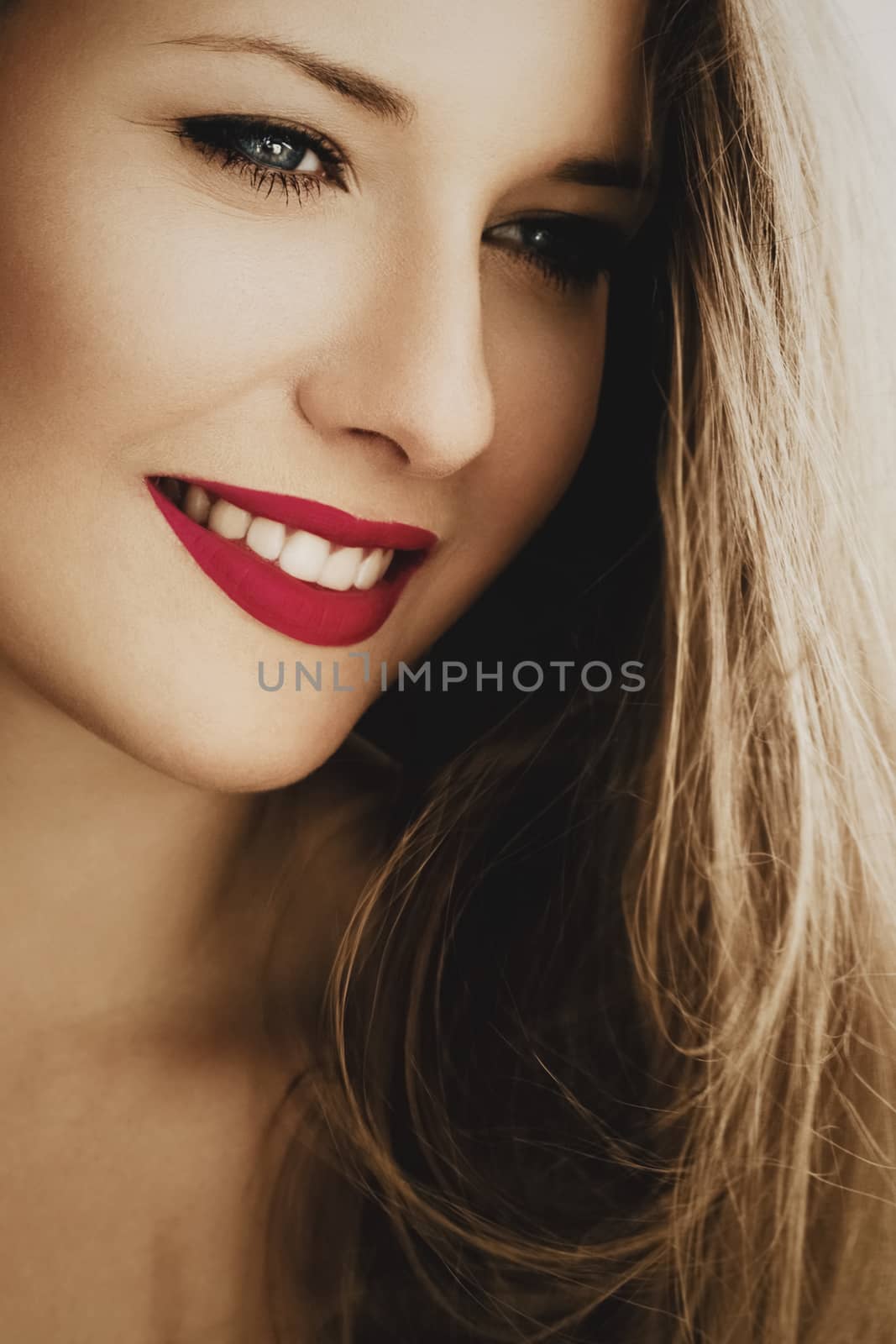 Attractive woman smiling, brunette with long light brown hair, girl wearing natural makeup look, female showing healthy white teeth, beauty portrait for cosmetic or lifestyle brands