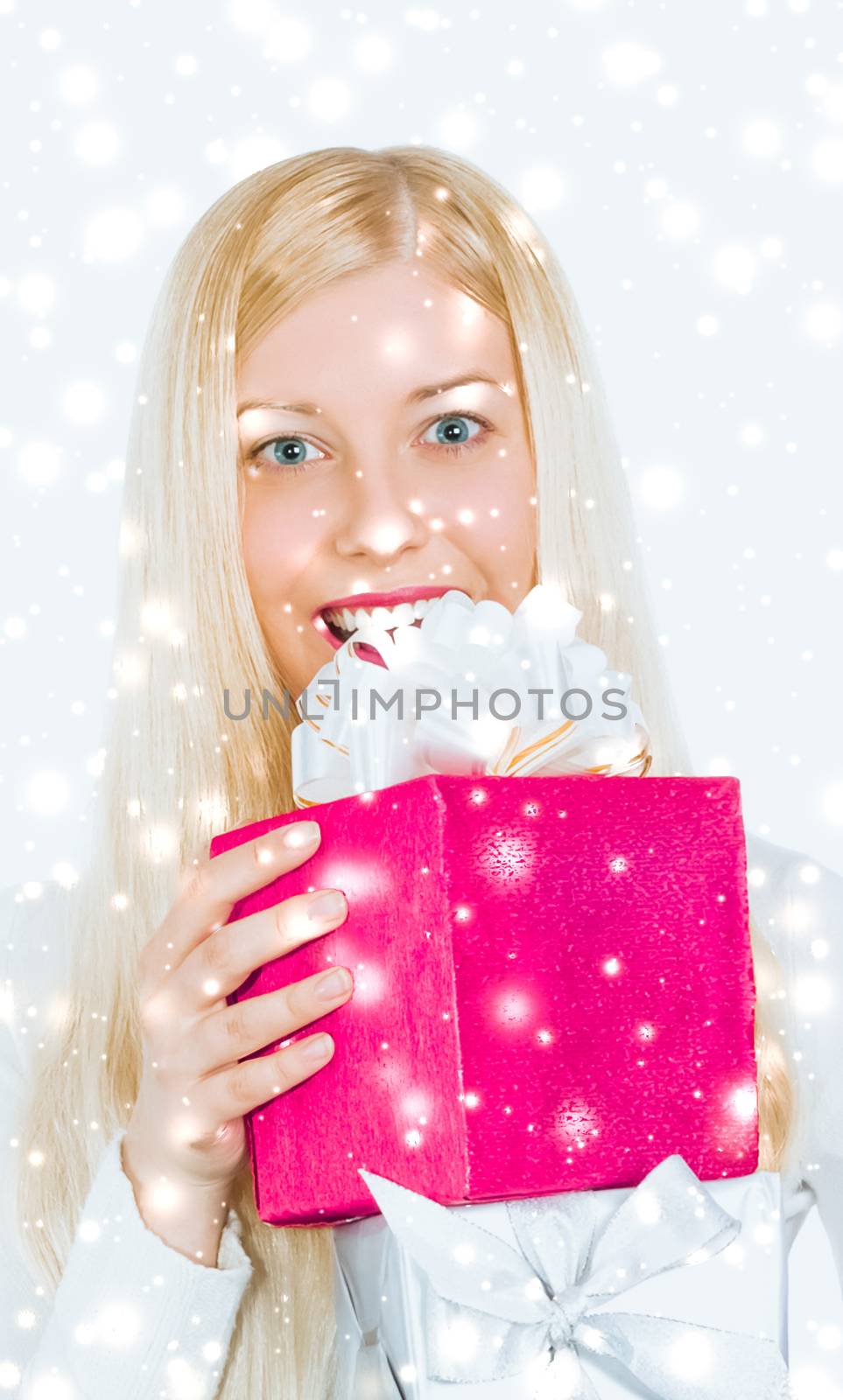 Magical Christmas and glitter snow background, happy blonde girl with gift boxes in winter season for shopping sale and holiday brands