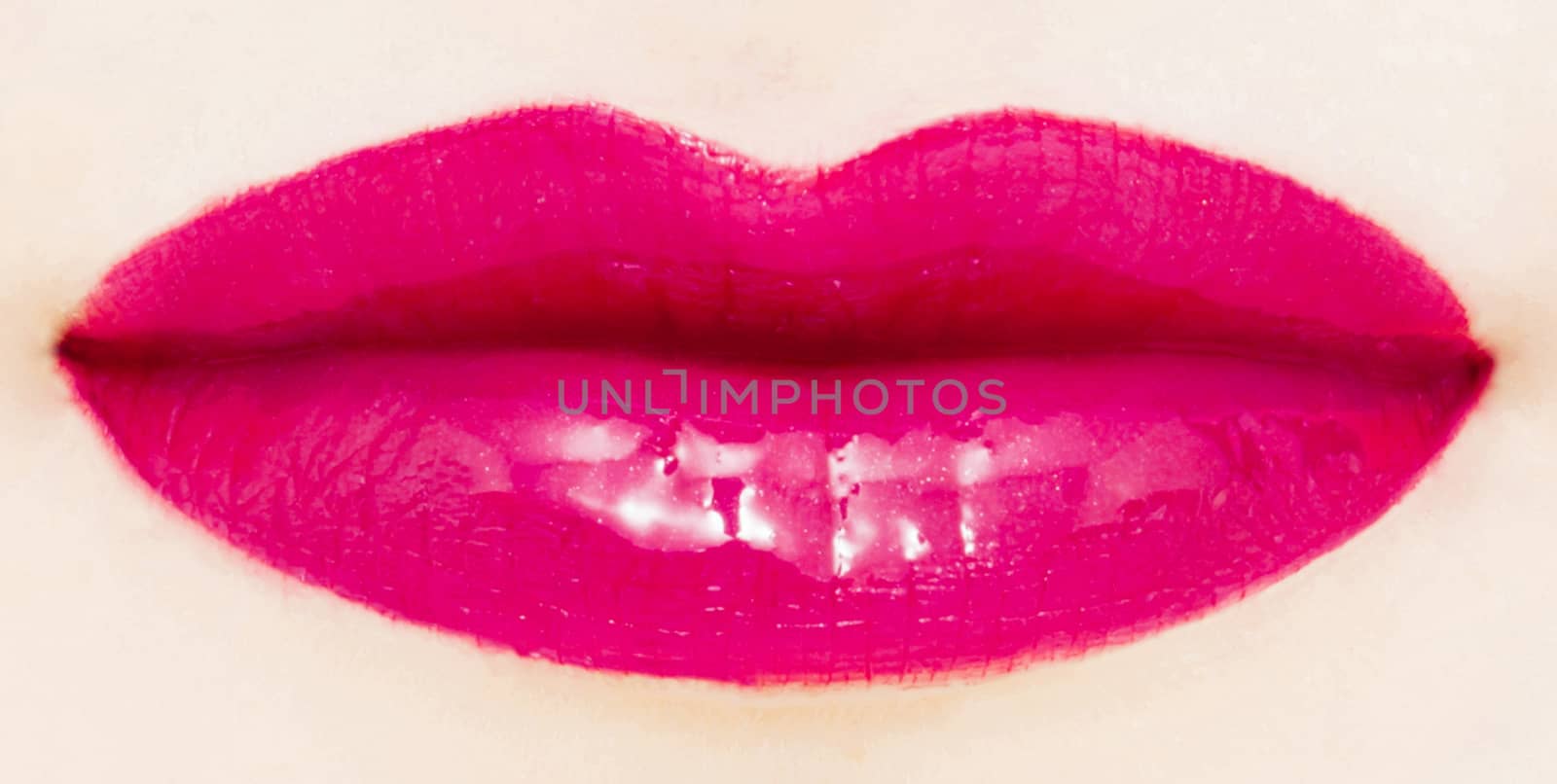 Female lips with glossy lipstick or lip gloss for make-up and beauty ads