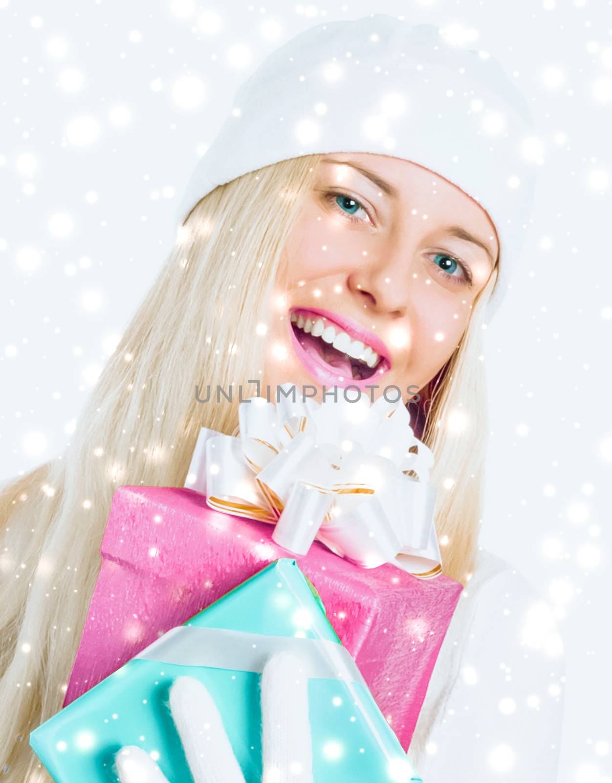Christmas surprise and glitter snow background, happy blonde girl with gift boxes in winter season for shopping sale and holiday brands