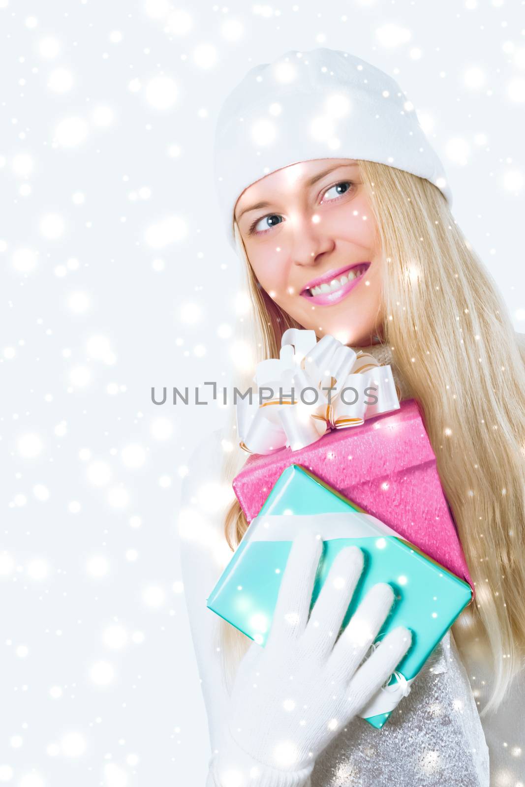 Christmas and glitter snow background, happy blonde girl with gift boxes in winter season for shopping sale and holiday brands