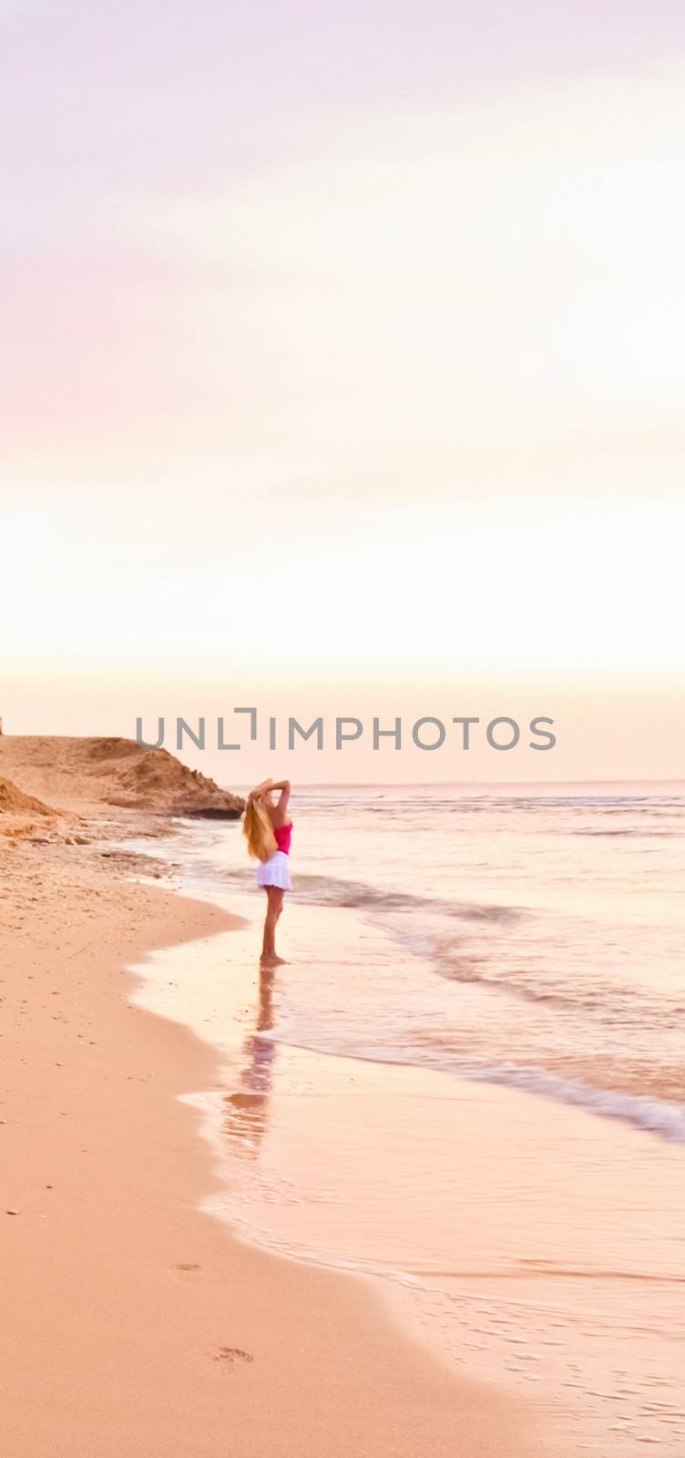 Girl and the sea at sunrise, travel and beach lifestyle concept