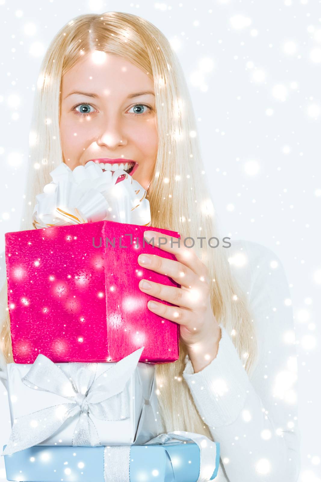 Christmas and glitter snow background, happy blonde girl with gift boxes in winter season for shopping sale and holiday brands