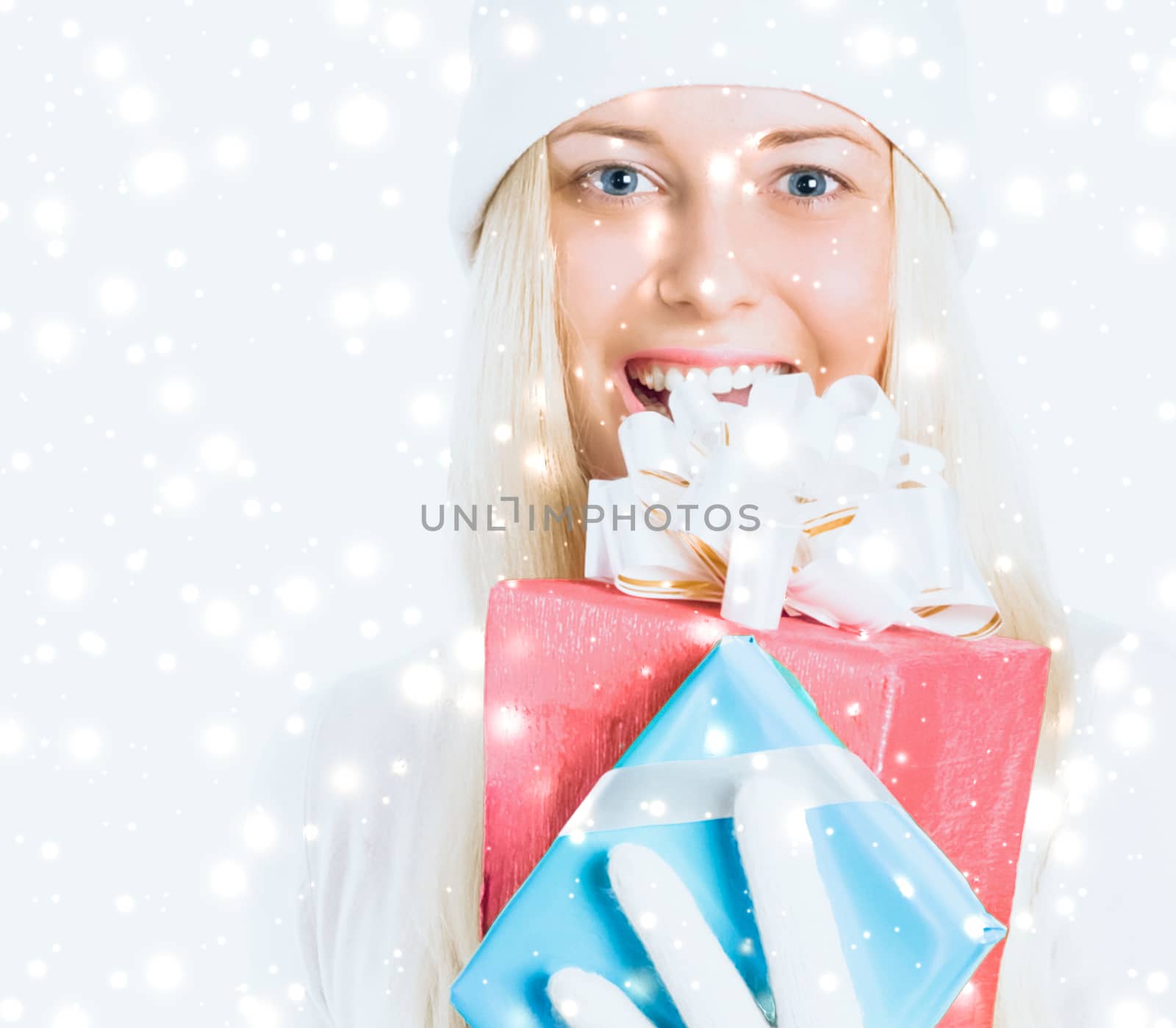 Christmas and glitter snow background, happy blonde girl with gift boxes in winter season for shopping sale and holiday brands