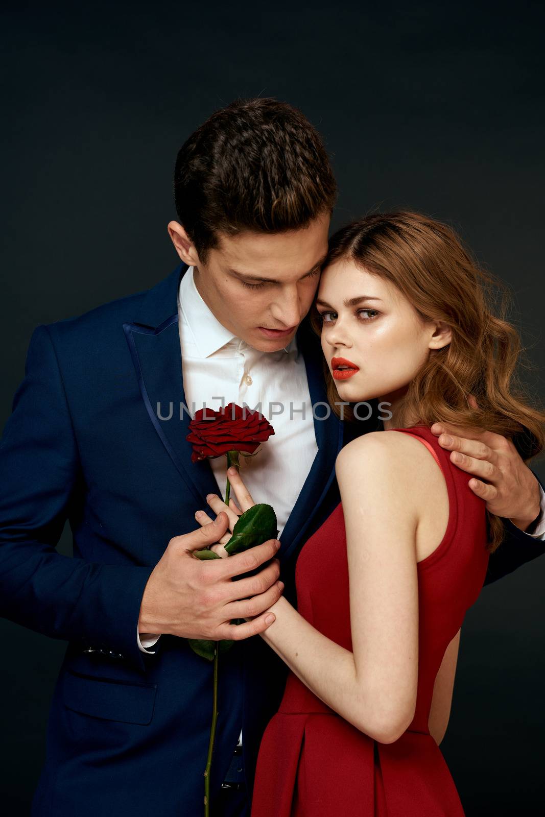 luxury couple hug romance relationship rose over dark isolated background. High quality photo