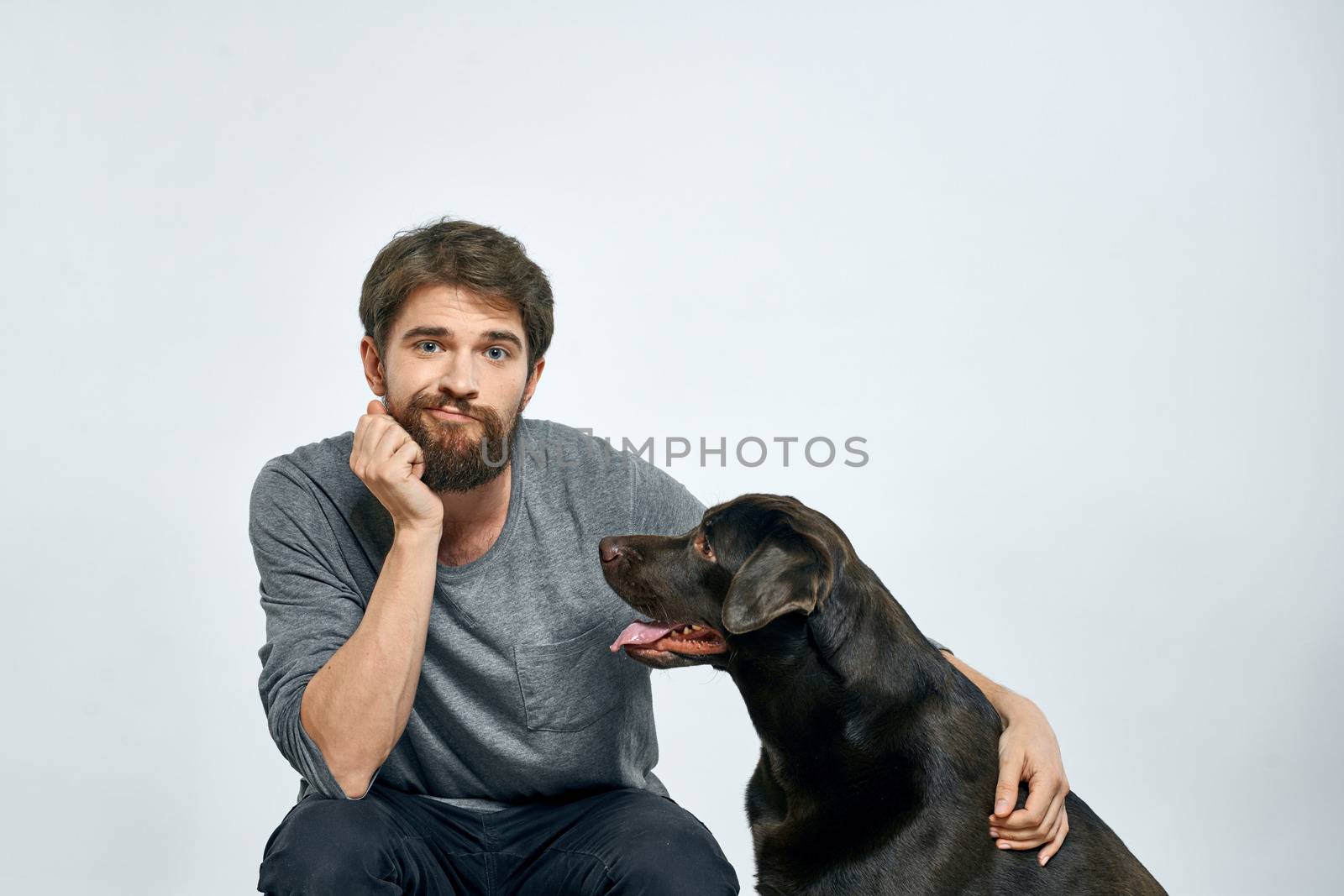 happy owner with pet black dog training model emotions by SHOTPRIME