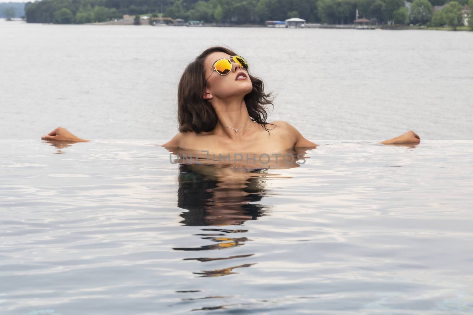 A gorgeous brunette model enjoys a day at the pool on a Caribbean island