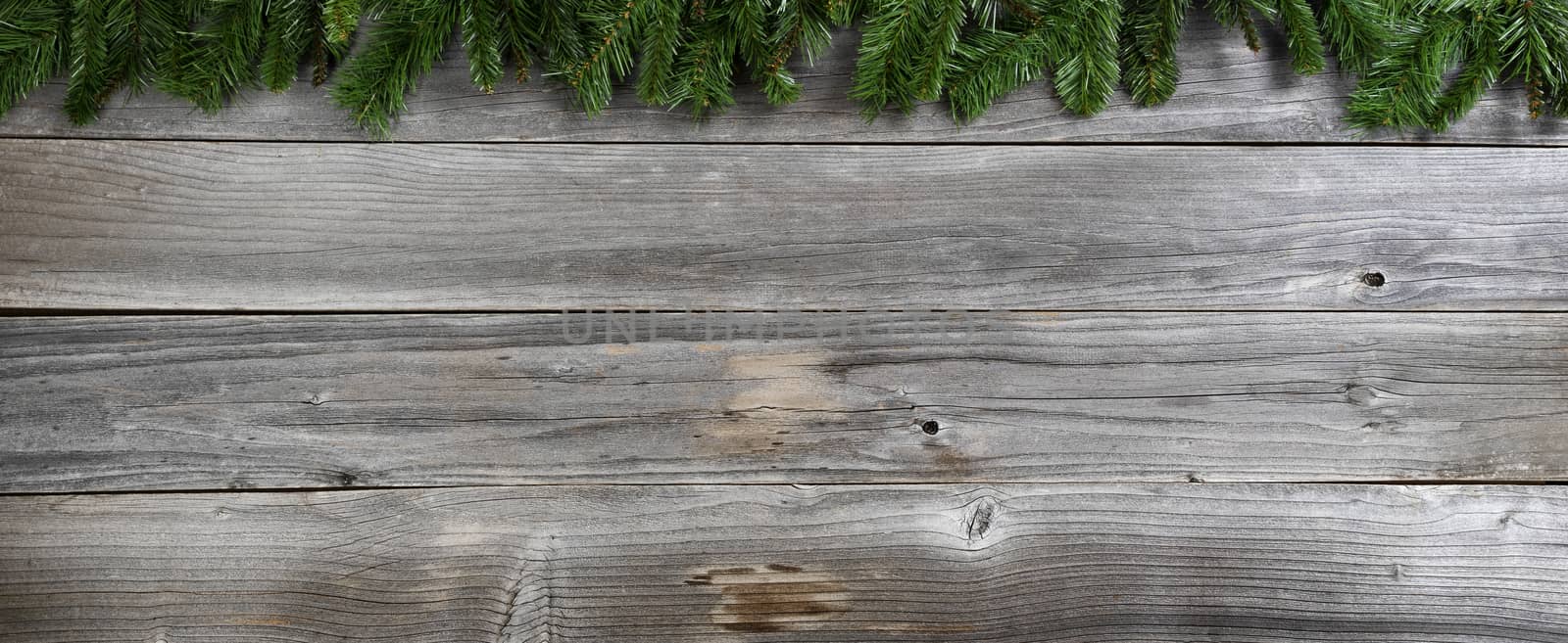 Merry Christmas and Happy New Year fir branches on rustic wood by tab1962