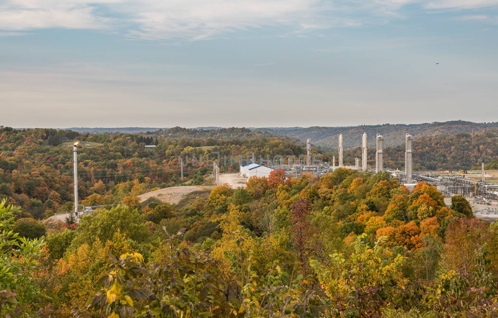 Overview of natural gas fracking pad near Moundsville West Virginia in the fall with autumn trees
