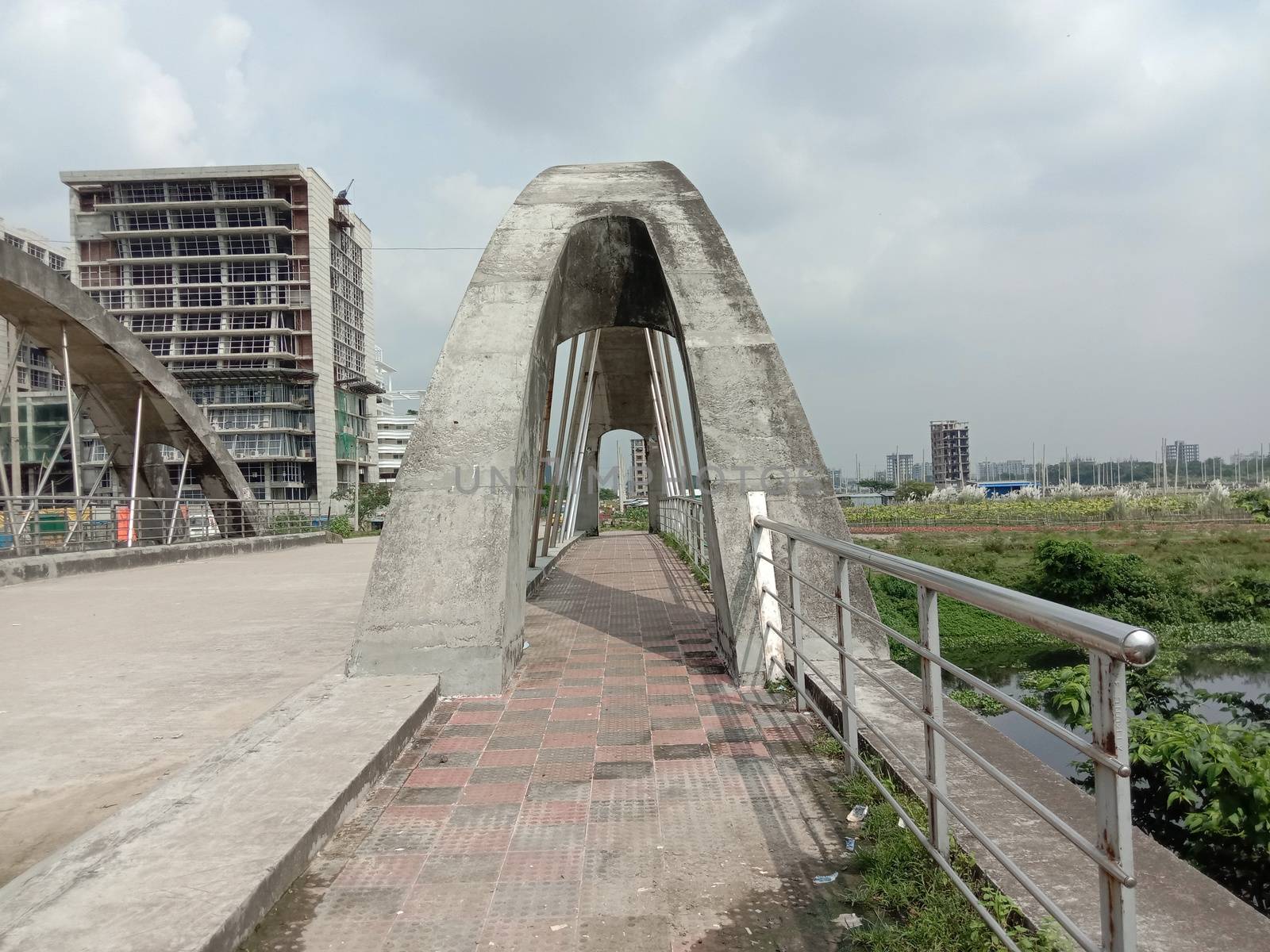 stylish steel and concrete bridge on lake