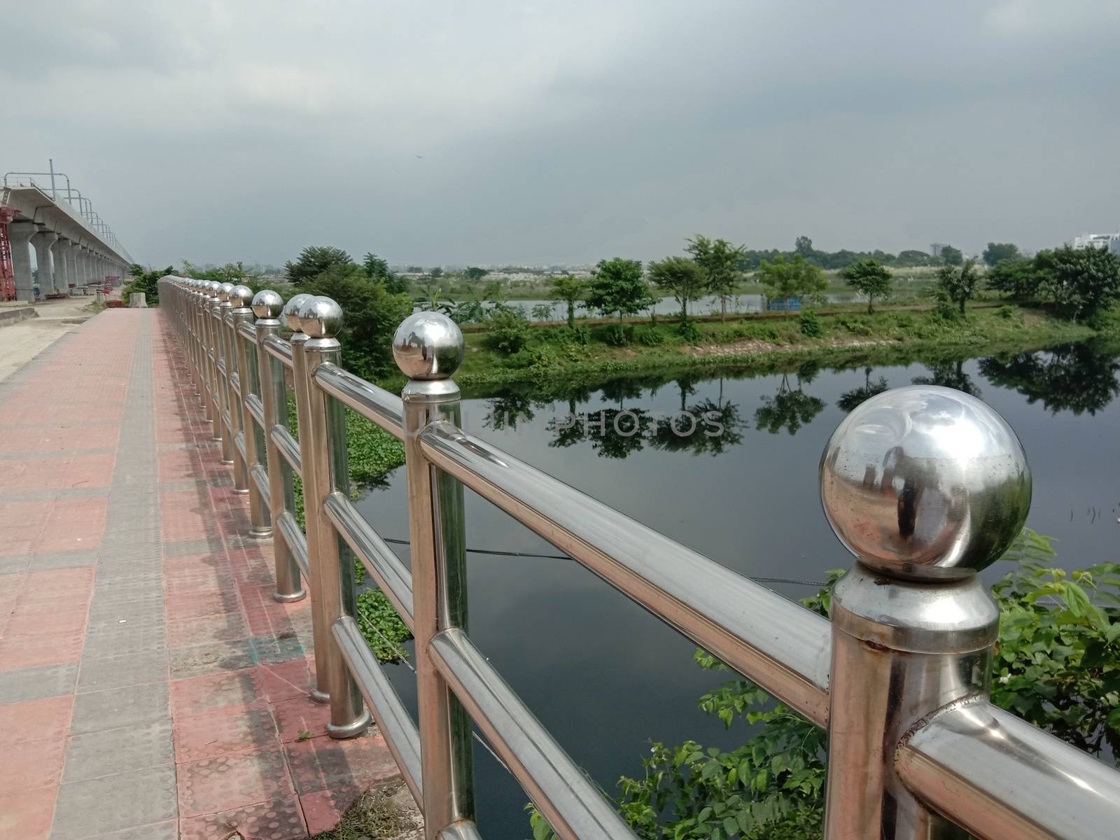 stylish steel and concrete bridge on lake