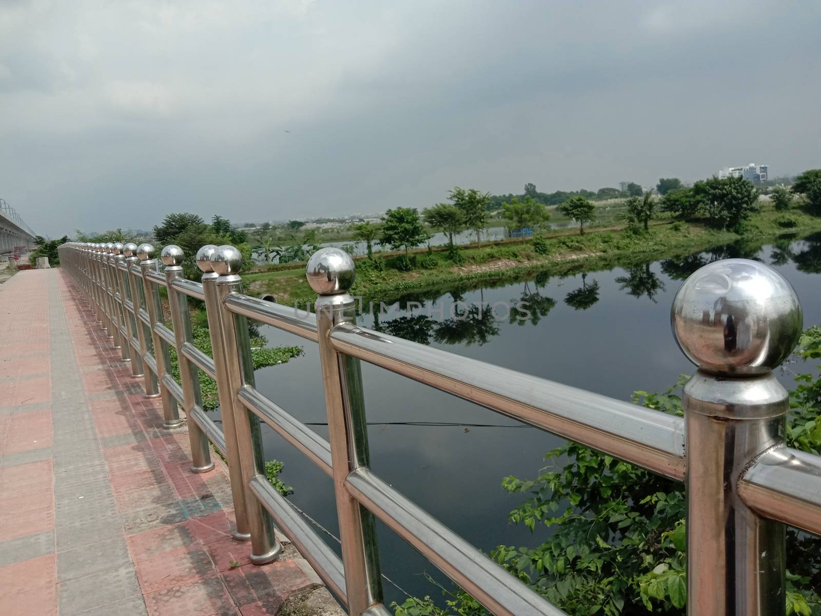 stylish steel and concrete bridge on lake