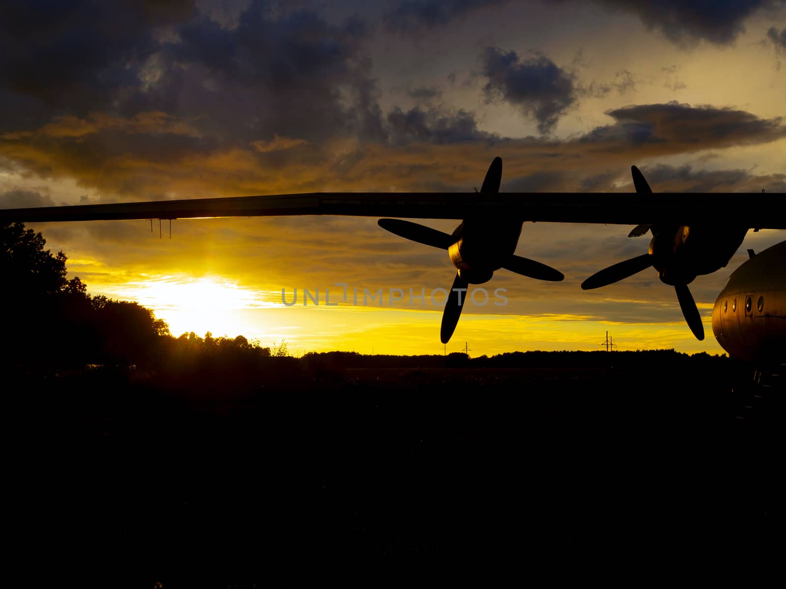 old Soviet military airplane, sunset time. Abandoned Historic Aircraft in Estonia AN-12. Close up of propeller engine. Copy space