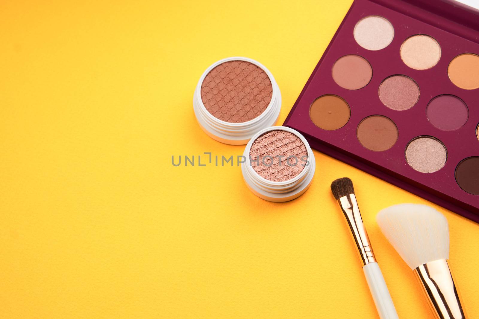eyeshadow powder blush makeup brushes yellow background Copy space by SHOTPRIME