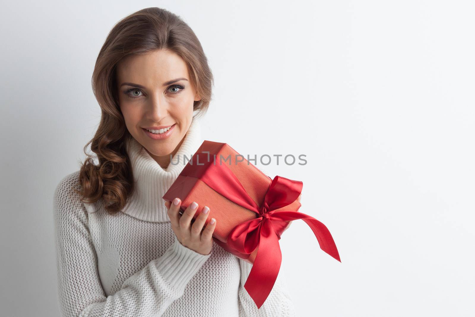 Smiling cute girl with red christmas gift box