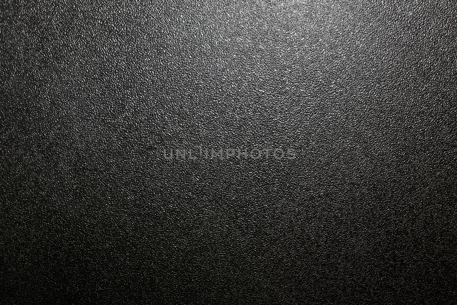Dark full frame background of hammered powder paint coating on flat sheet steel surface. Also known as hammertone effect.