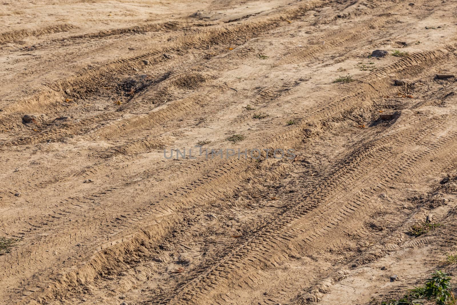 dusty dry dirt road under direct sun light - full frame close-up shot