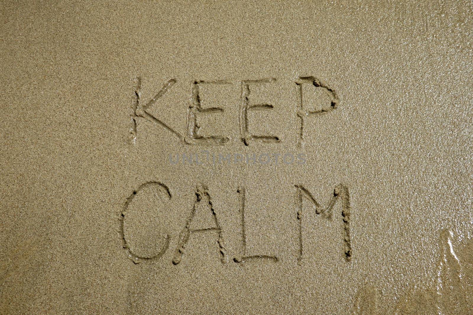 The sign keep calm written on sand, stress free concept.