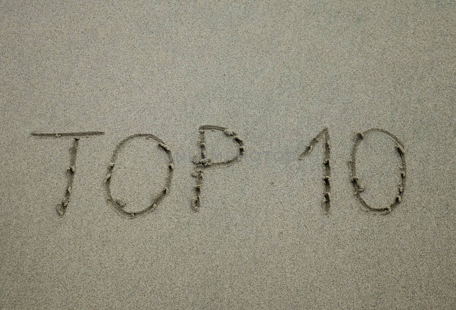 The sign top 10, written on the sand beach.