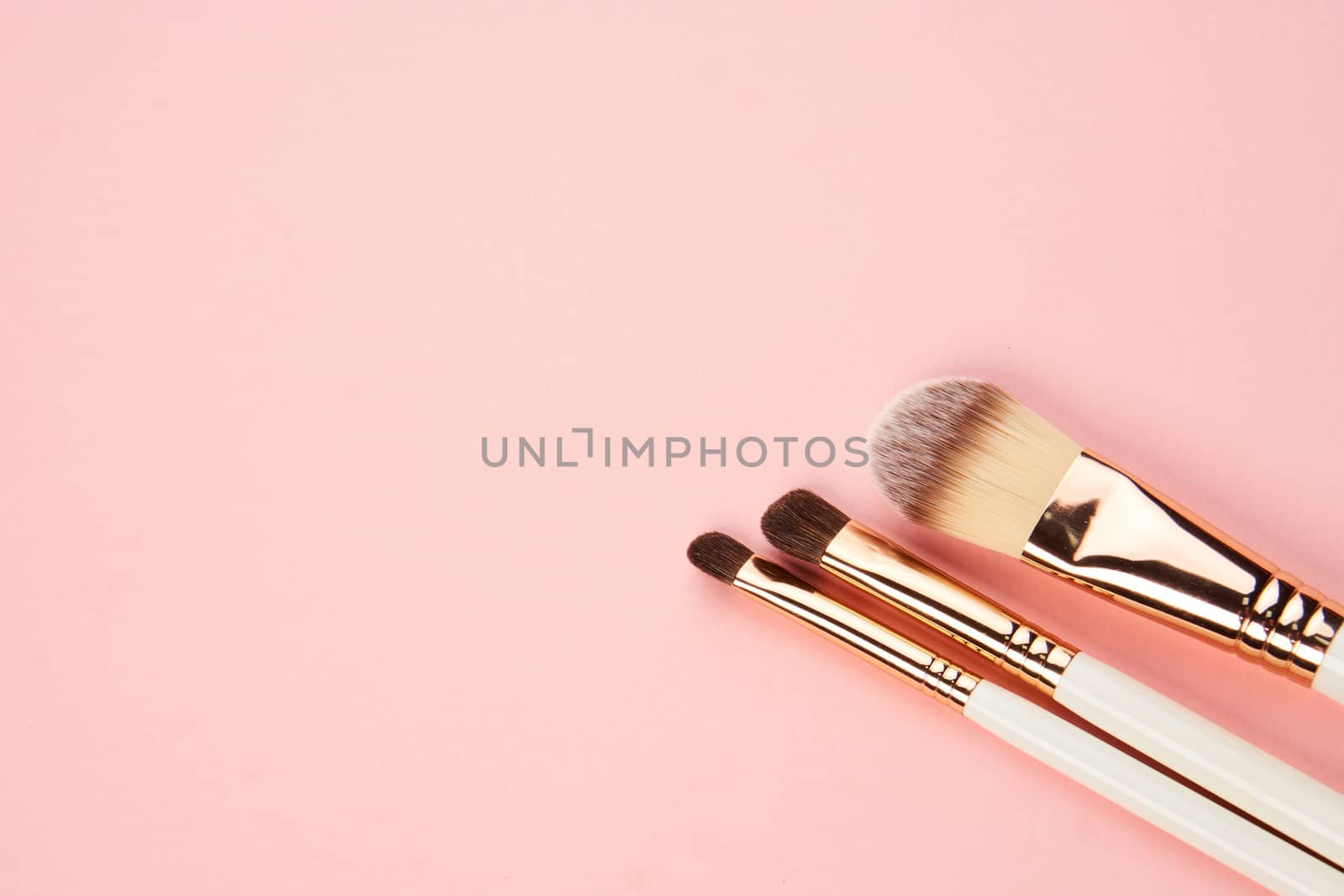 eyeshadow makeup brushes collection professional cosmetics accessories on pink background. High quality photo