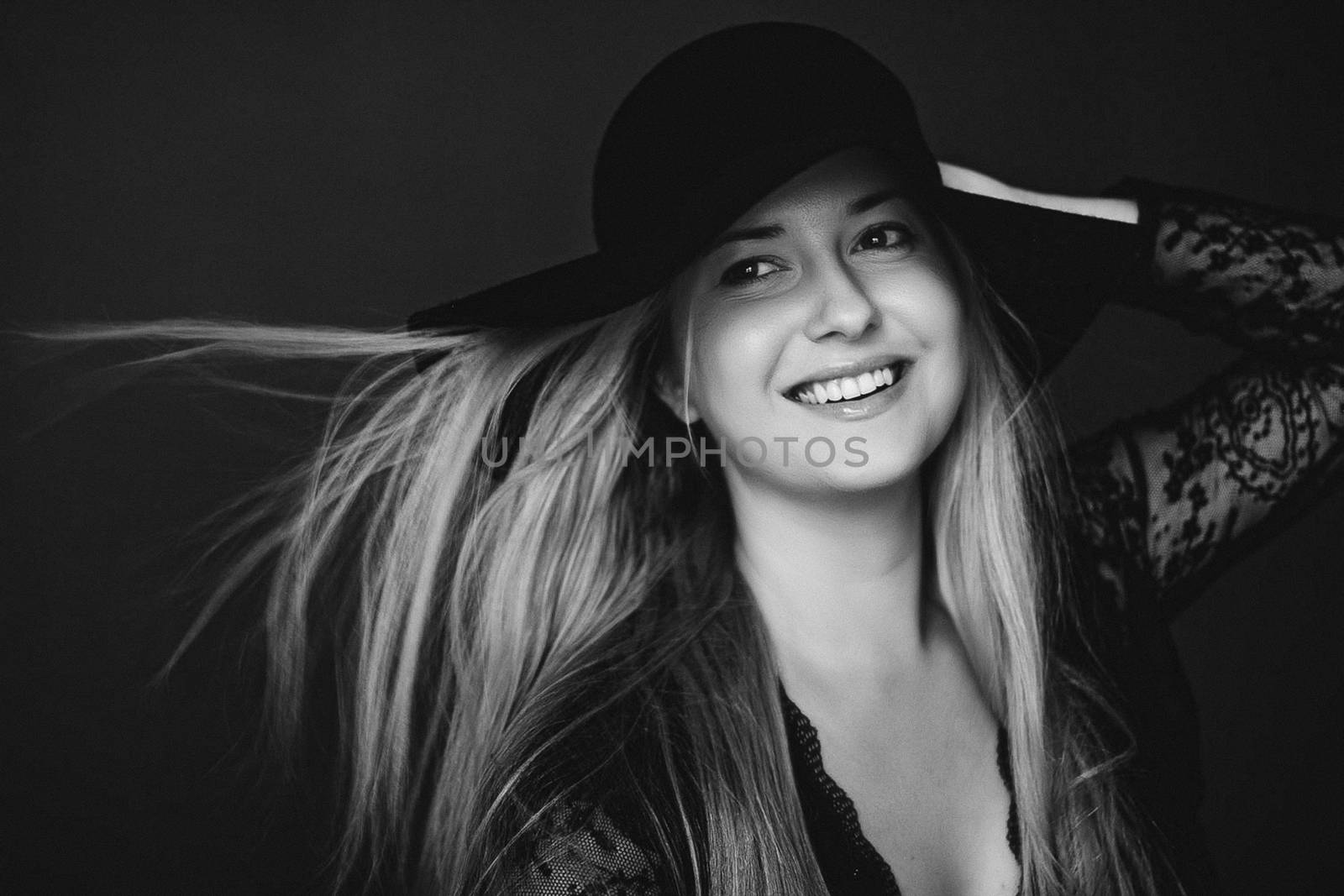 Beautiful blonde woman wearing a hat, artistic film portrait in  by Anneleven