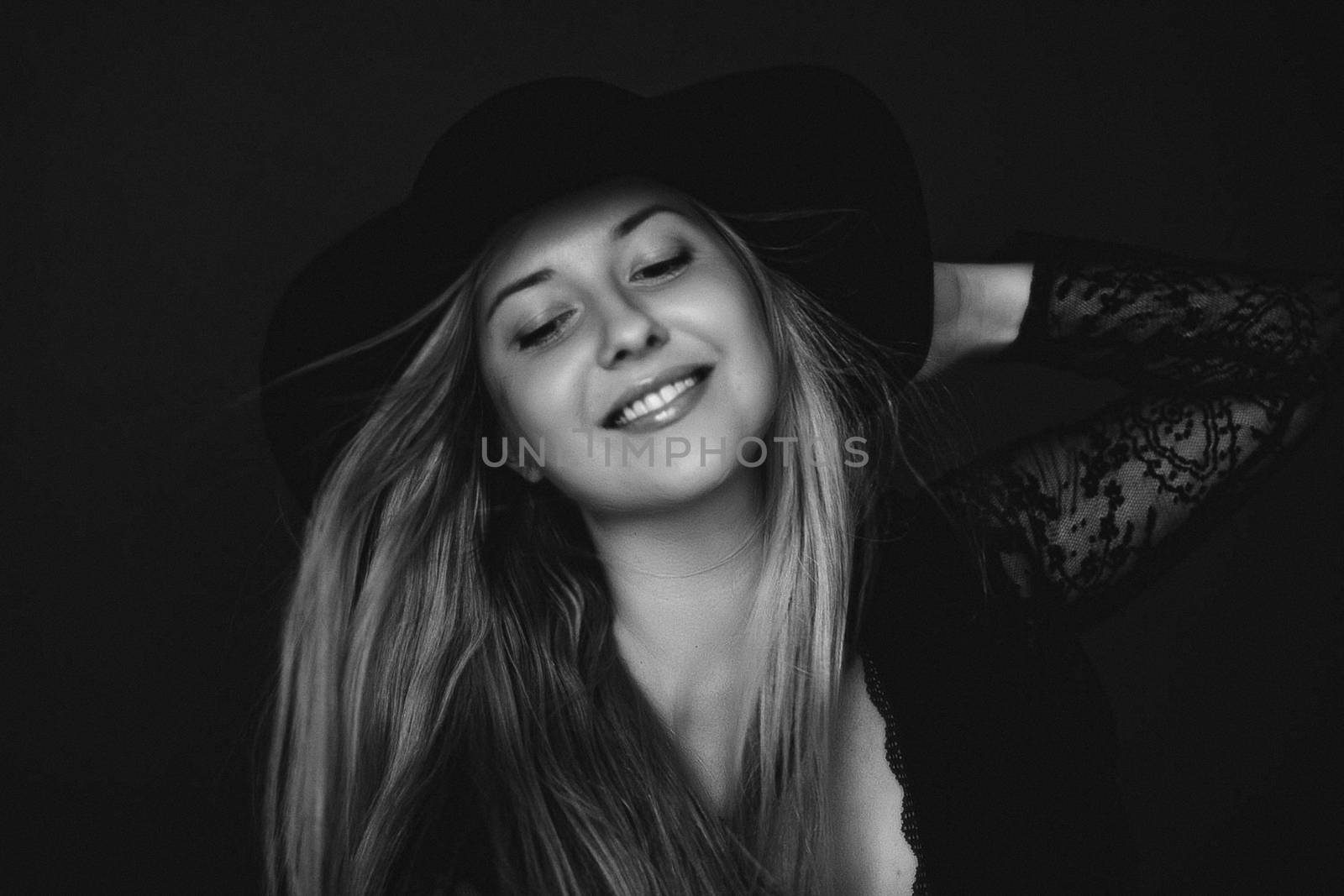 Beautiful blonde woman wearing a hat, artistic film portrait in  by Anneleven