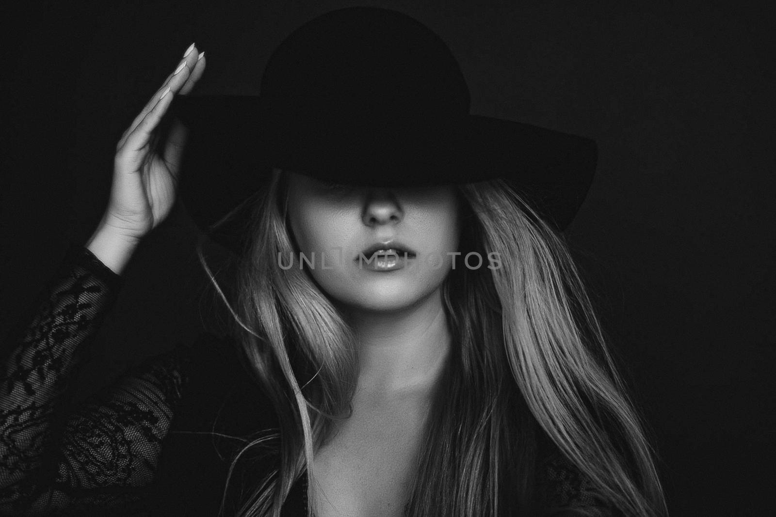 Beautiful blonde woman wearing a hat, artistic film portrait in  by Anneleven