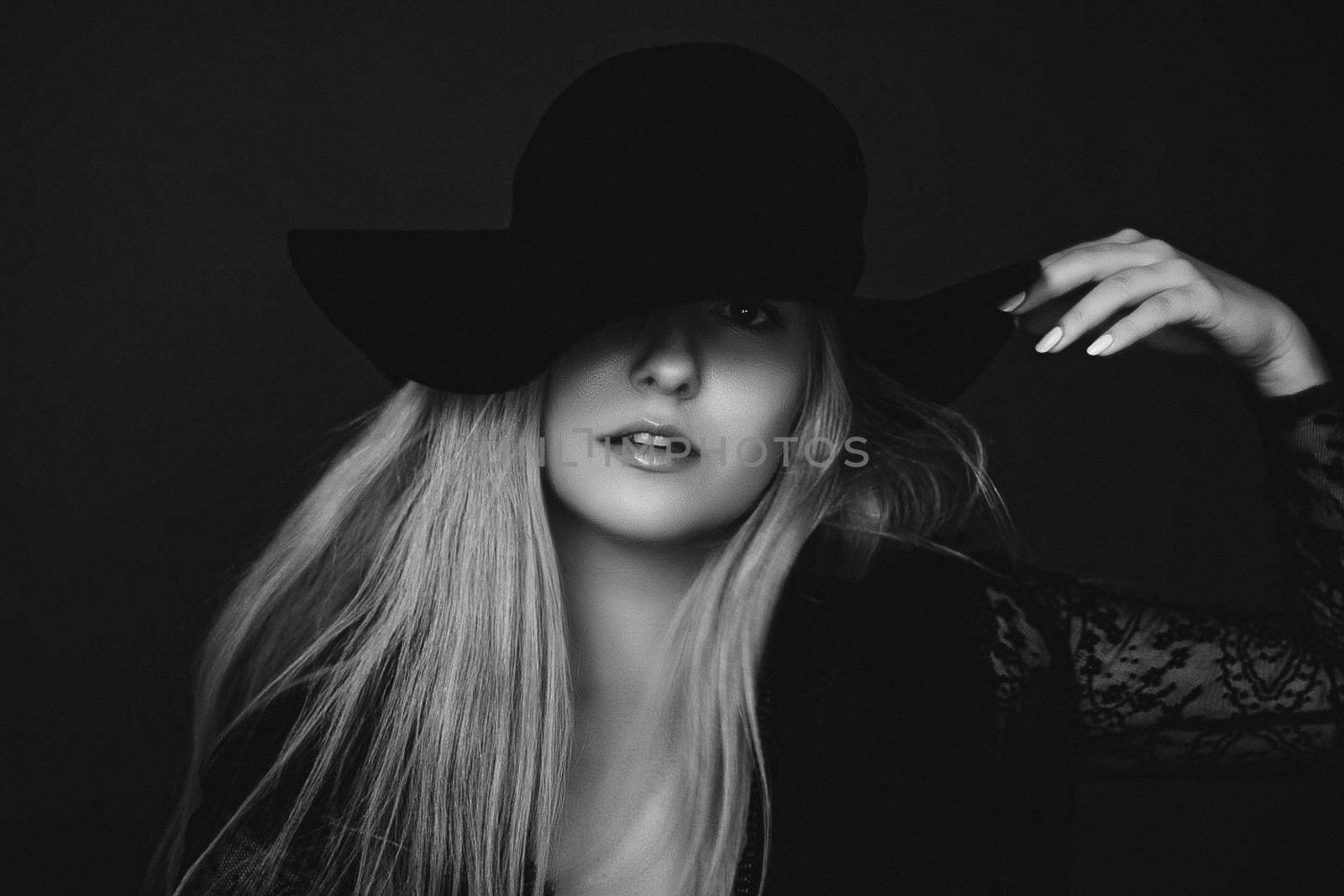 Beautiful blonde woman wearing a hat, artistic film portrait in  by Anneleven