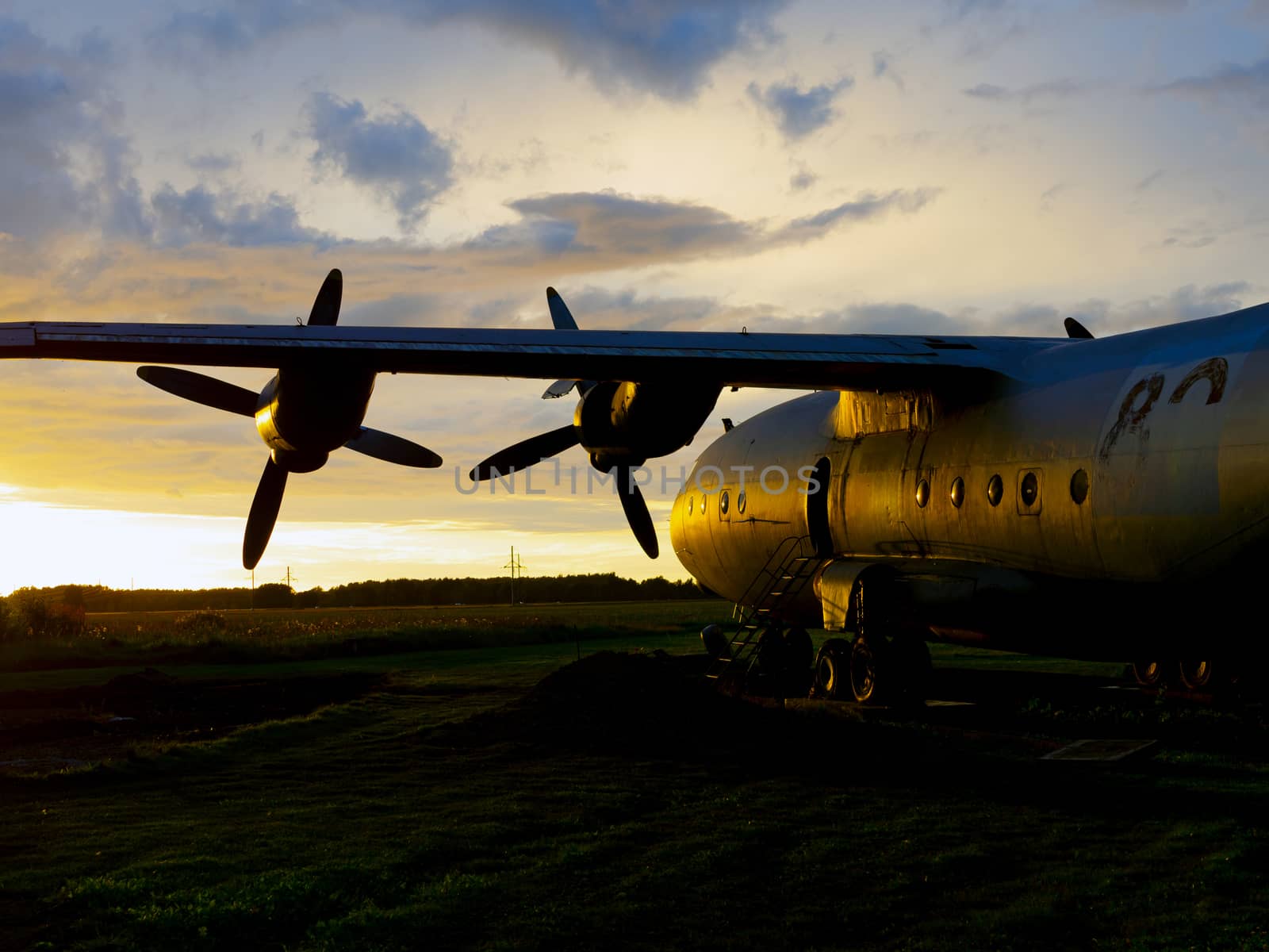 old Soviet military airplane, sunset time. Abandoned Historic Aircraft. Close up of propeller engine. Copy space