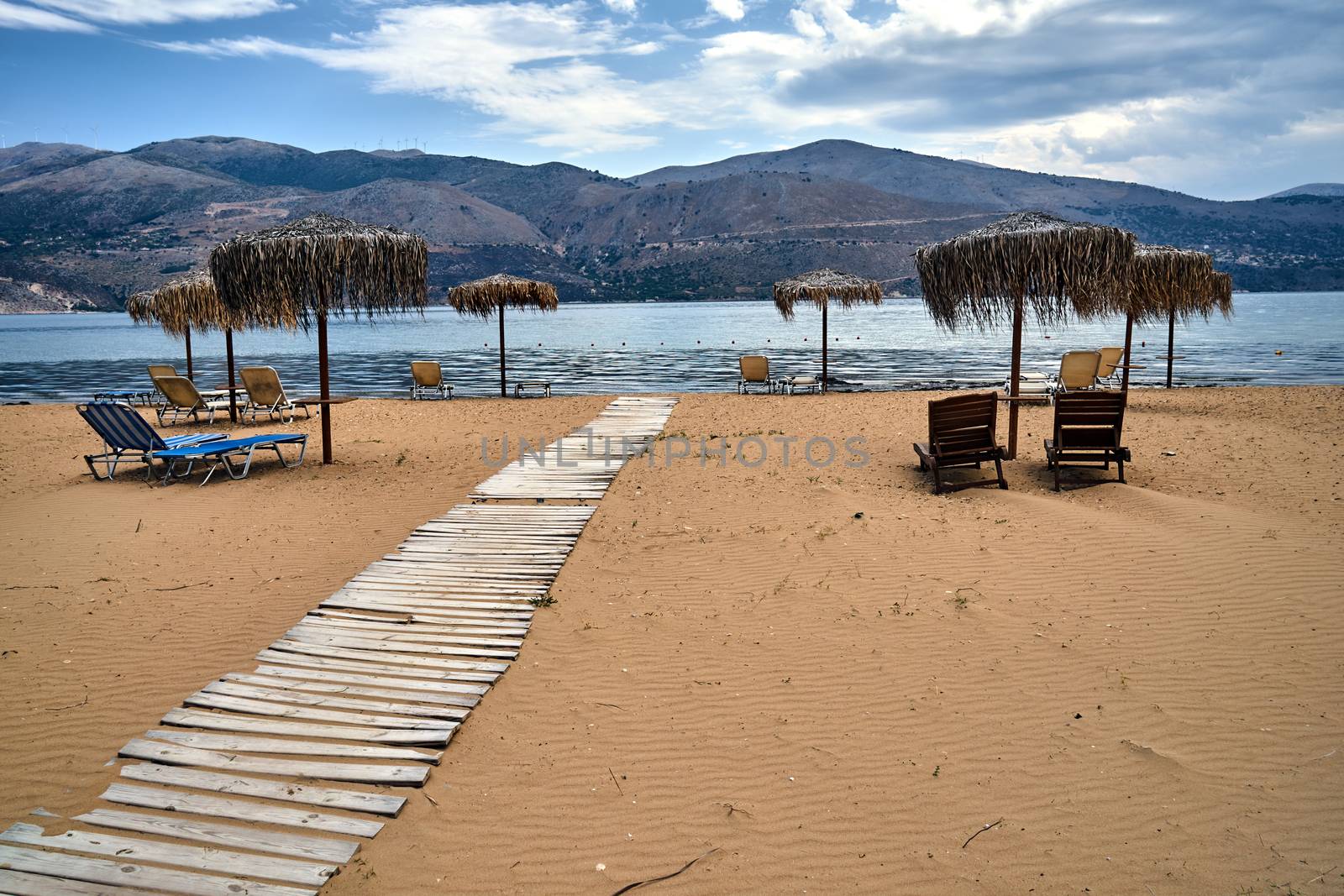 Umbrellas on an empty sandy beach on Kefalonia island in Greece