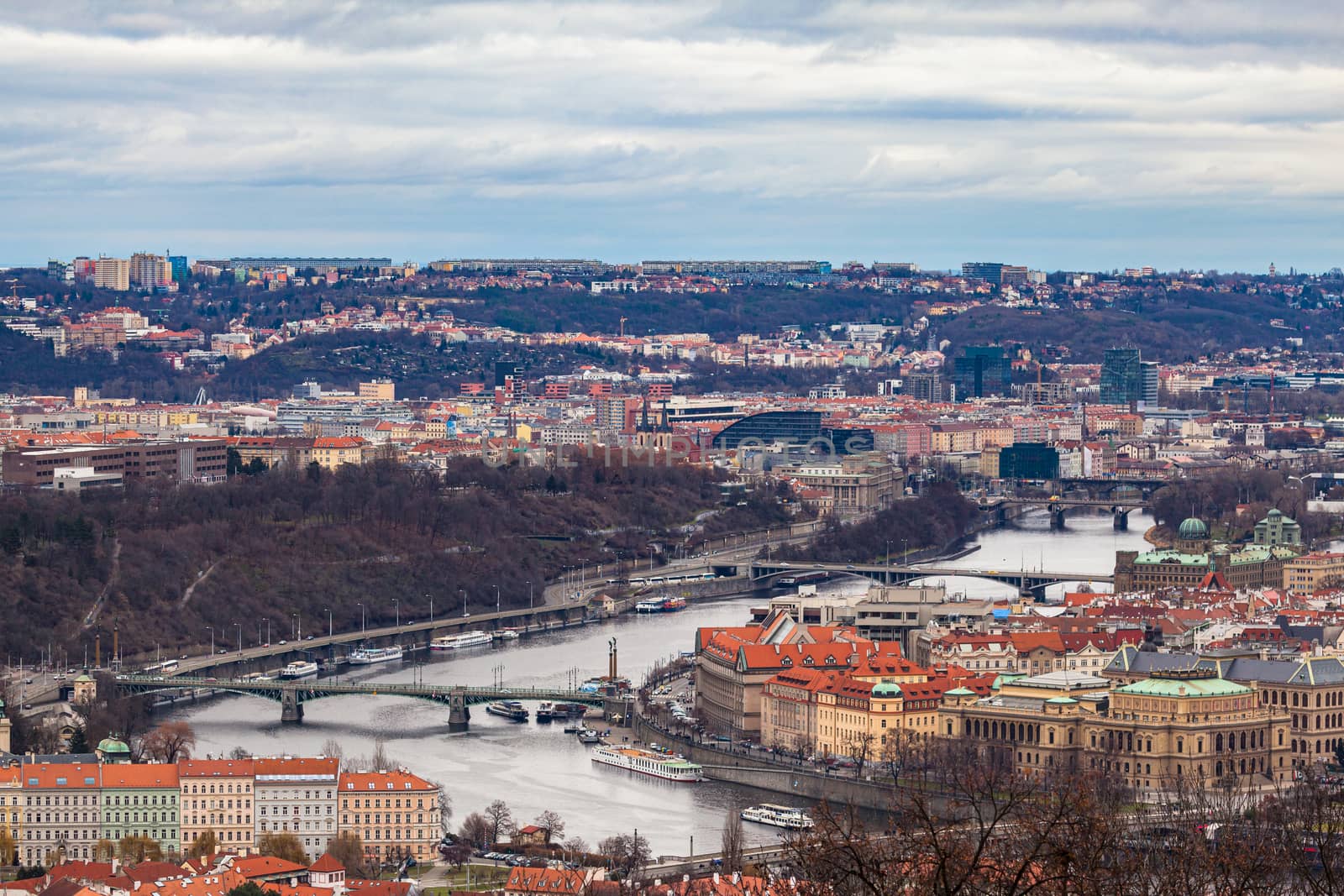 Aerial view of bridges over Vltava river and cityscape of Prague old town with historic buildings from Petrin Hill on the day with Czech Republic