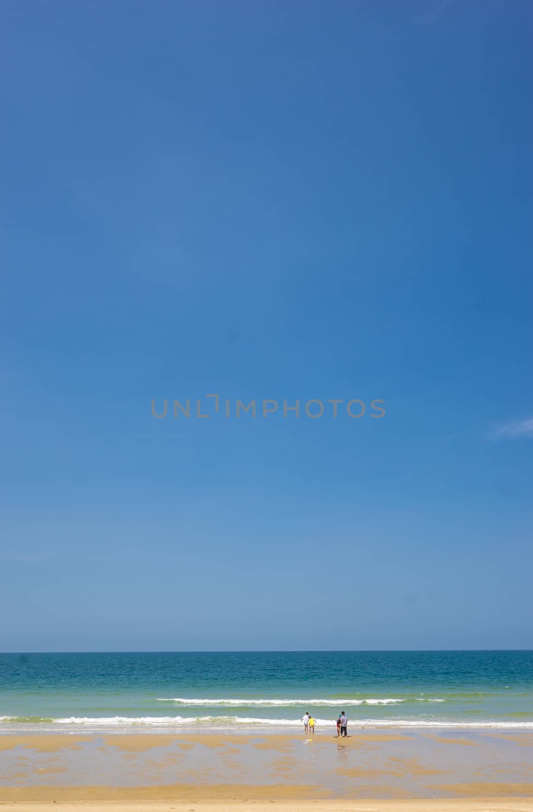 people on the beach and blue sky background