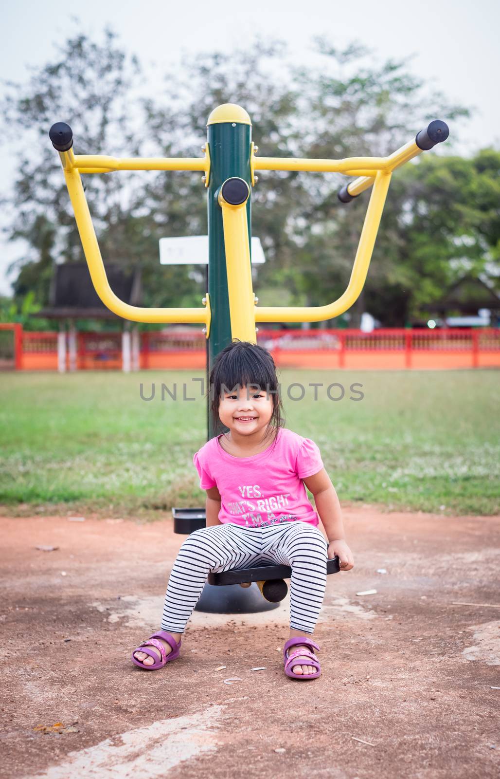 portrait of little girl exercise in the park