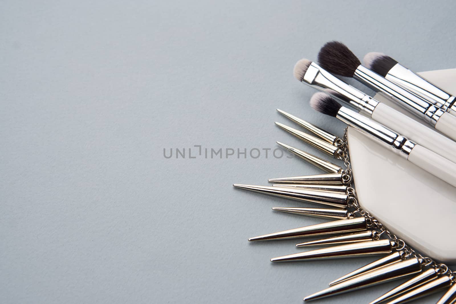 professional makeup brushes on stand on gray background and copy space cropped view. High quality photo