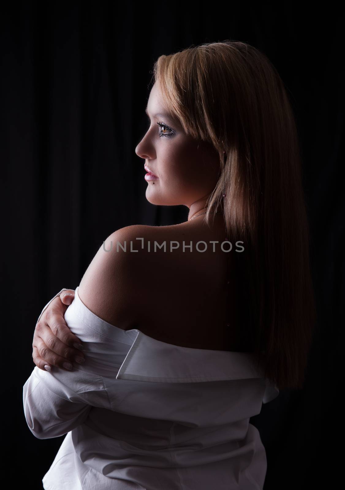 Young blonde woman in white shirt looking into the distance by 25ehaag6