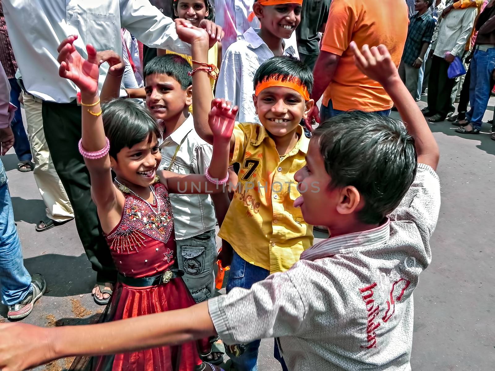 Children dancing in front of ganesh idol during festival process by lalam