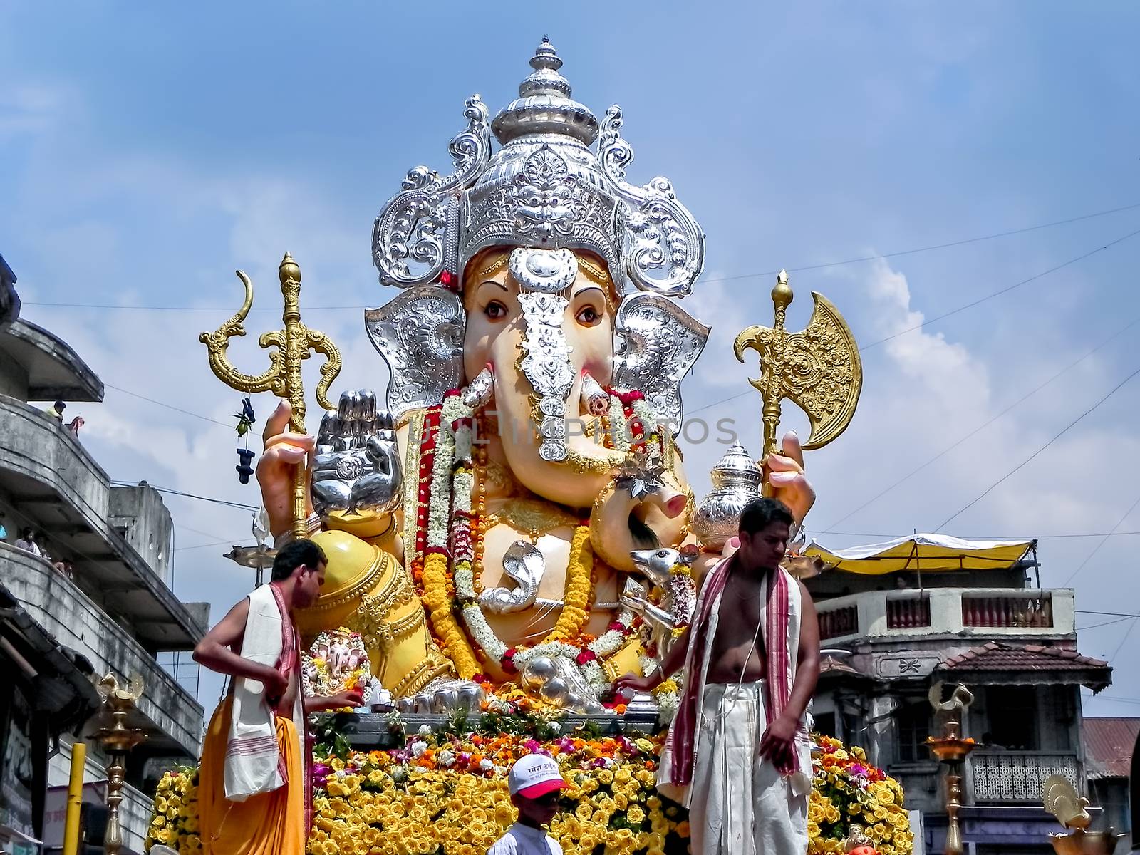 Decorated & garlanded huge idol of Hindu God Ganesha during festival procession. by lalam