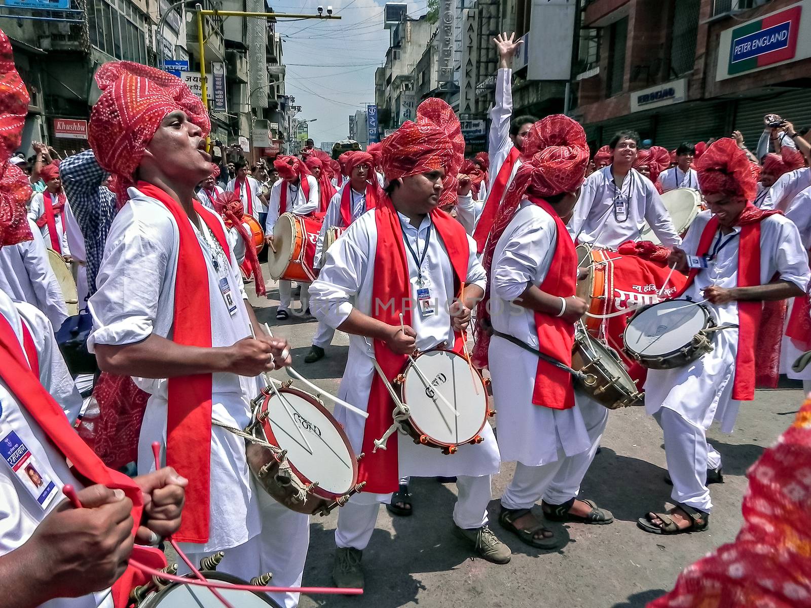 Pune,Maharashtra,India-September 22nd,2010: Group of youths beating traditional tasha collectively during festival procession of ganesh as people in crowd watch.