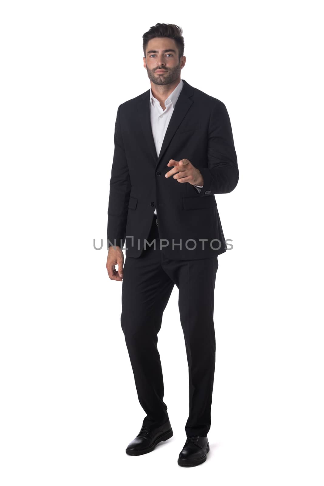 Full length portrait of young handsome business man pointing to the camera isolated on white background, business people