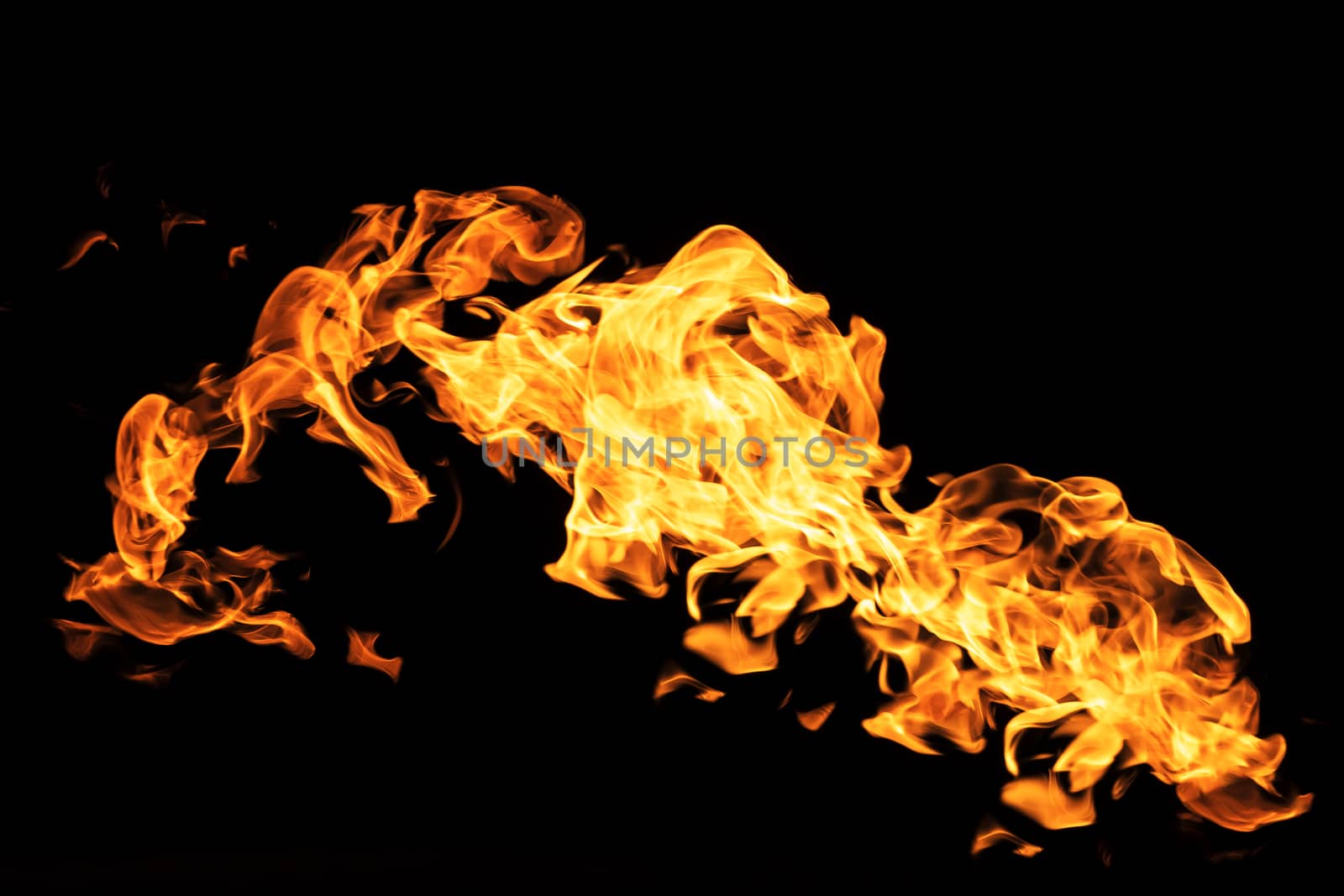 Fire flames on black background isolated. Burning gas or gasoline burns with fire and flames. Flaming burning sparks close-up, fire patterns. Infernal glow of fire in the dark with copy-space