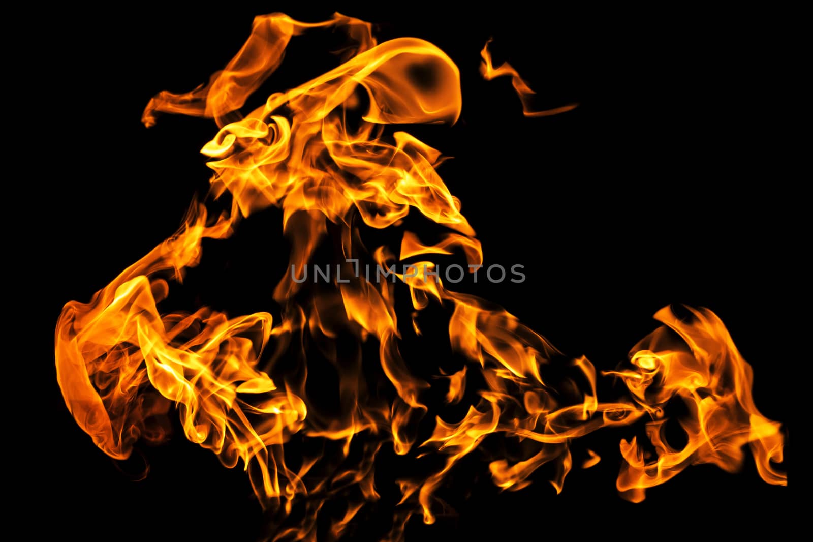 Fire flames on black background isolated. Burning gas or gasoline burns with fire and flames. Flaming burning sparks close-up, fire patterns. Infernal glow of fire in the dark with copy-space