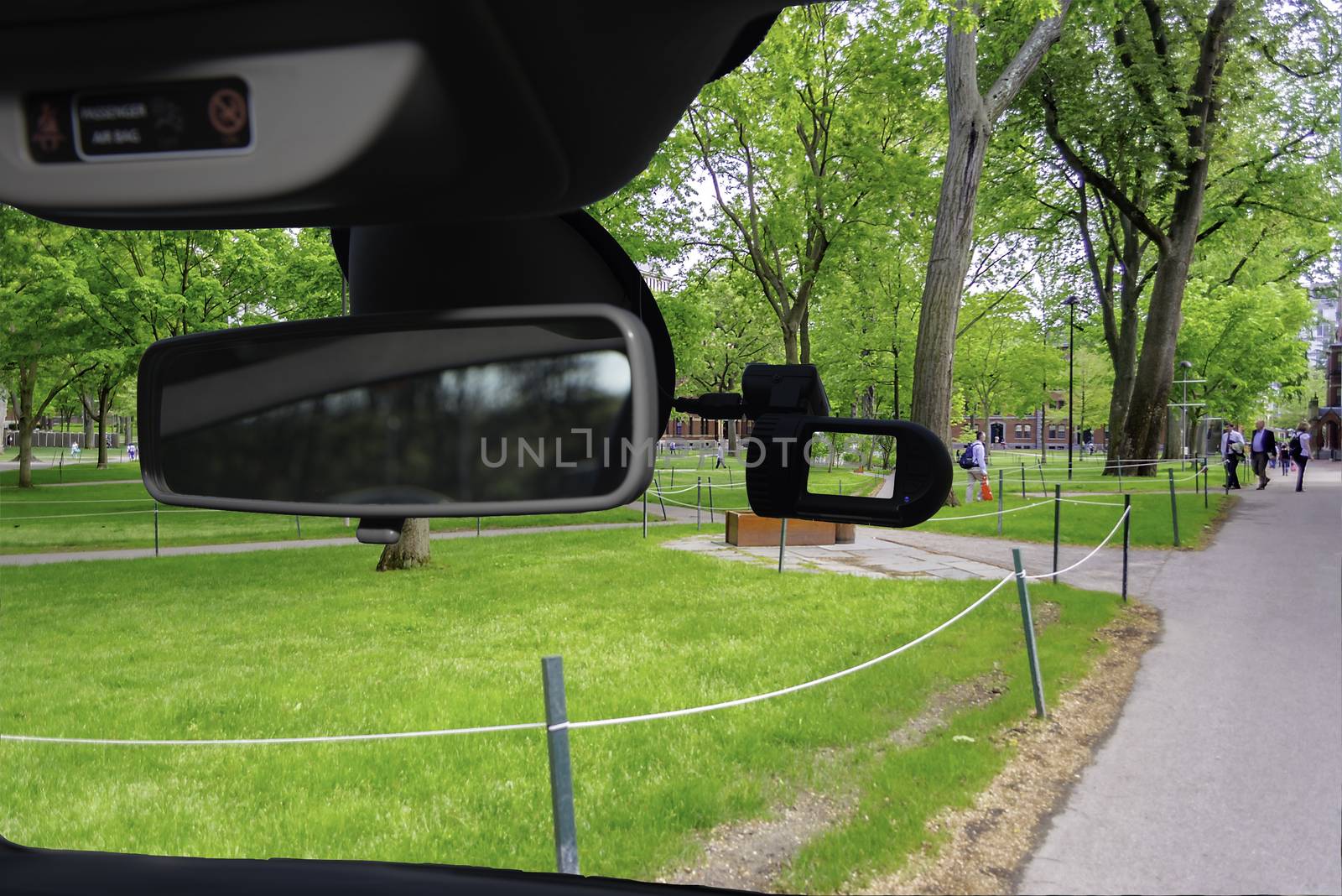Looking through a dashcam car camera installed on a windshield with view of the Harvard University Campus, Cambridge, USA