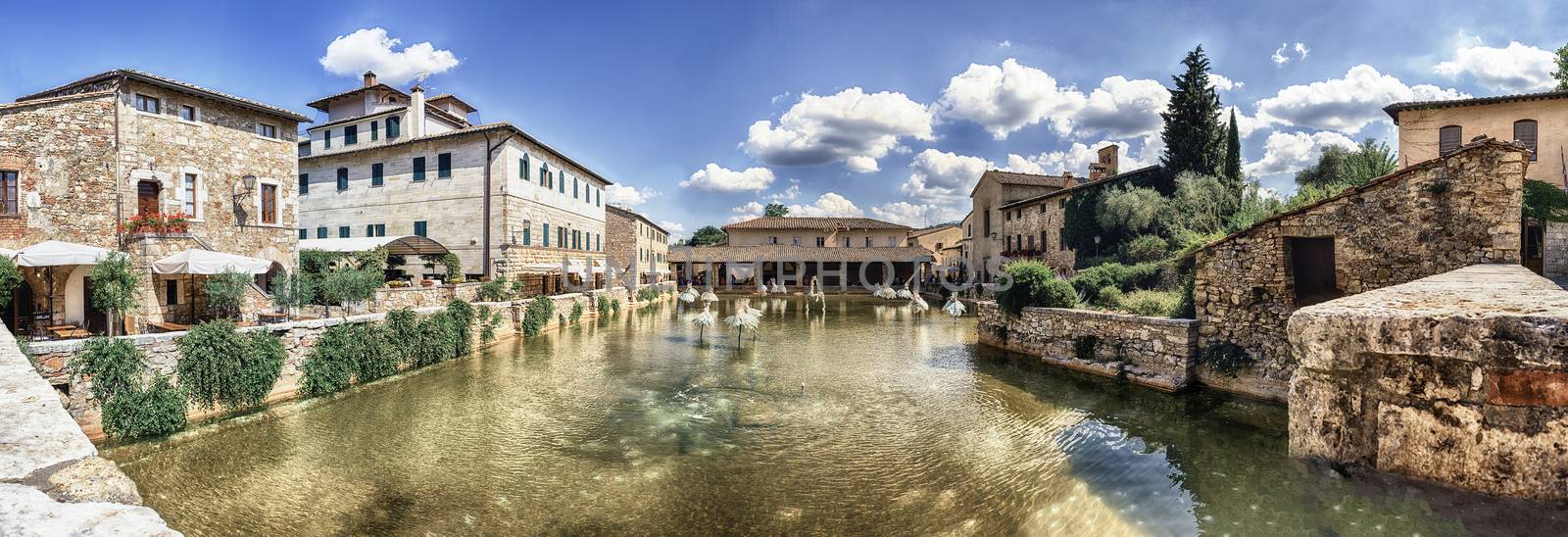 Panoramic view of the iconic medieval thermal baths, major landmark and sightseeing in the town of Bagno Vignoni, province of Siena, Tuscany, Italy
