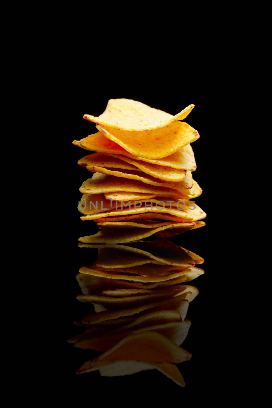 mexican nachos tortilla chips stack, black background