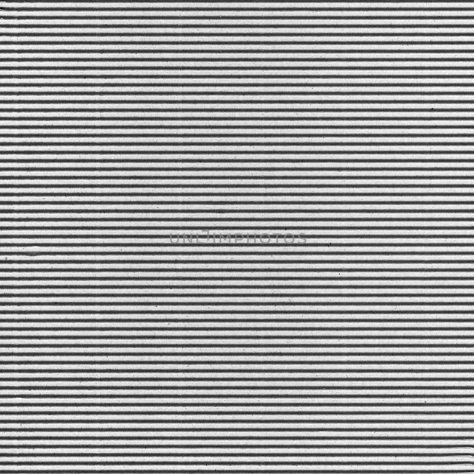 white corrugated cardboard texture background by claudiodivizia