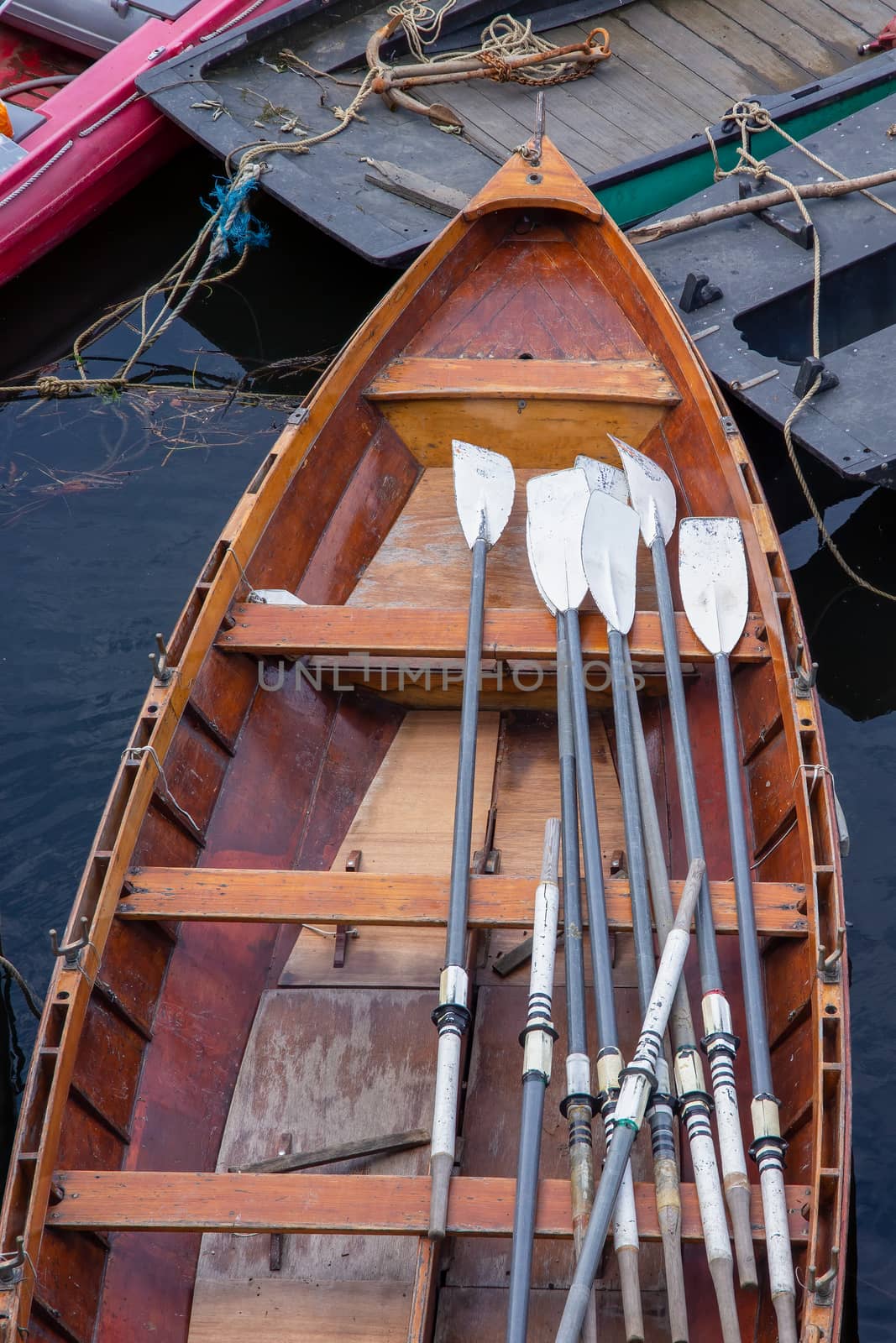 Wooden rowing boat for hire, moored on the River Thames, London, England by magicbones