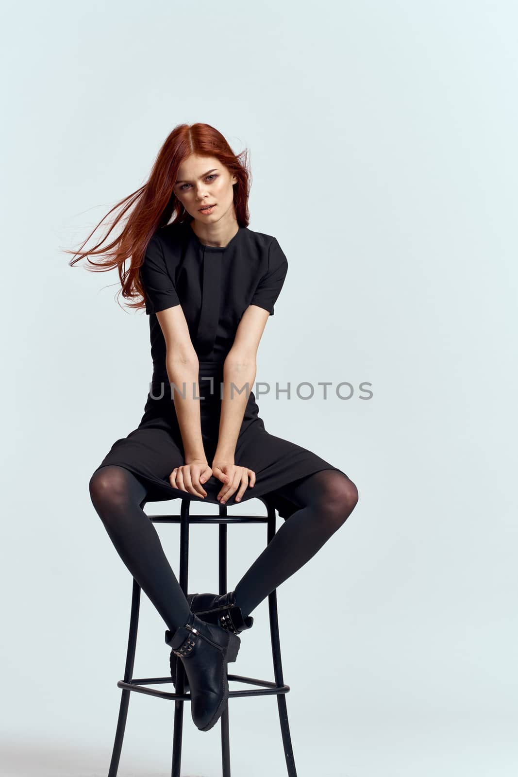 woman high chair indoors full length black dress red hair model boots by SHOTPRIME