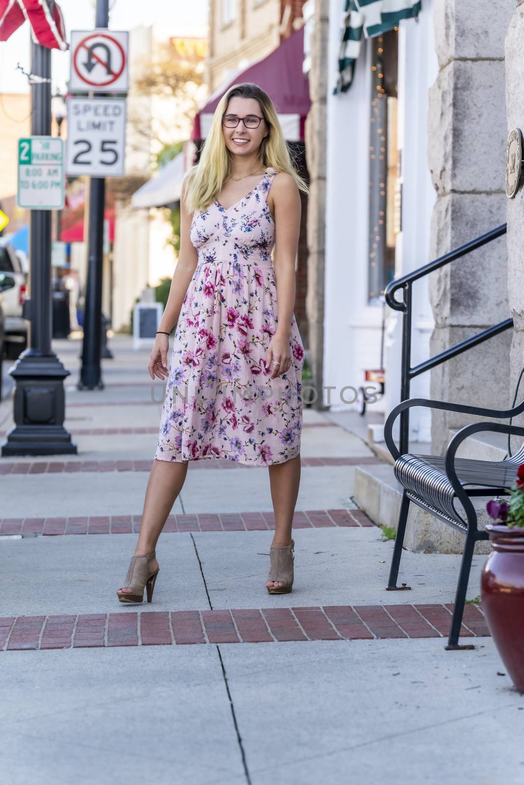 A gorgeous blonde model enjoys a summers day outdoors in a small town