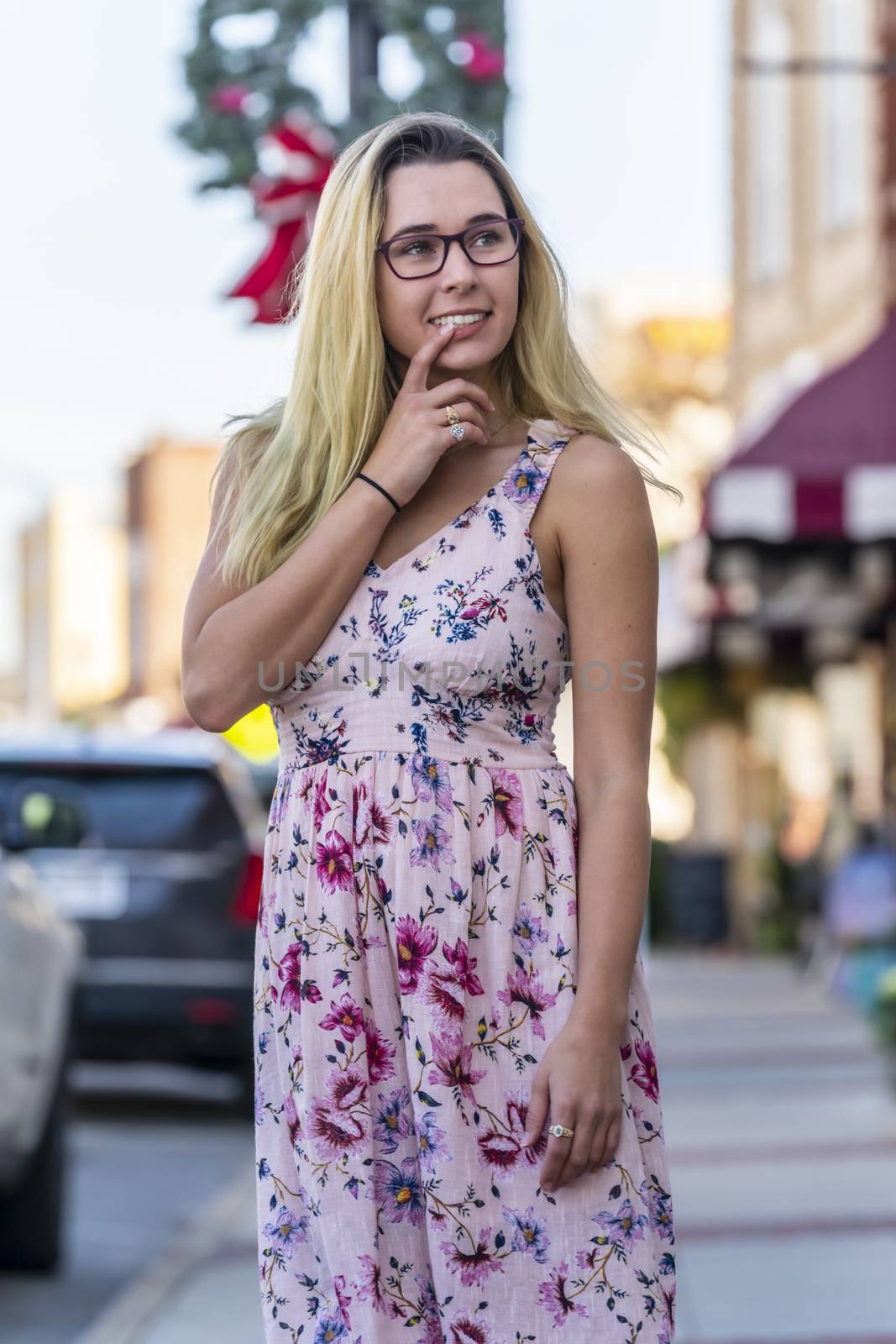 A gorgeous blonde model enjoys a summers day outdoors in a small town