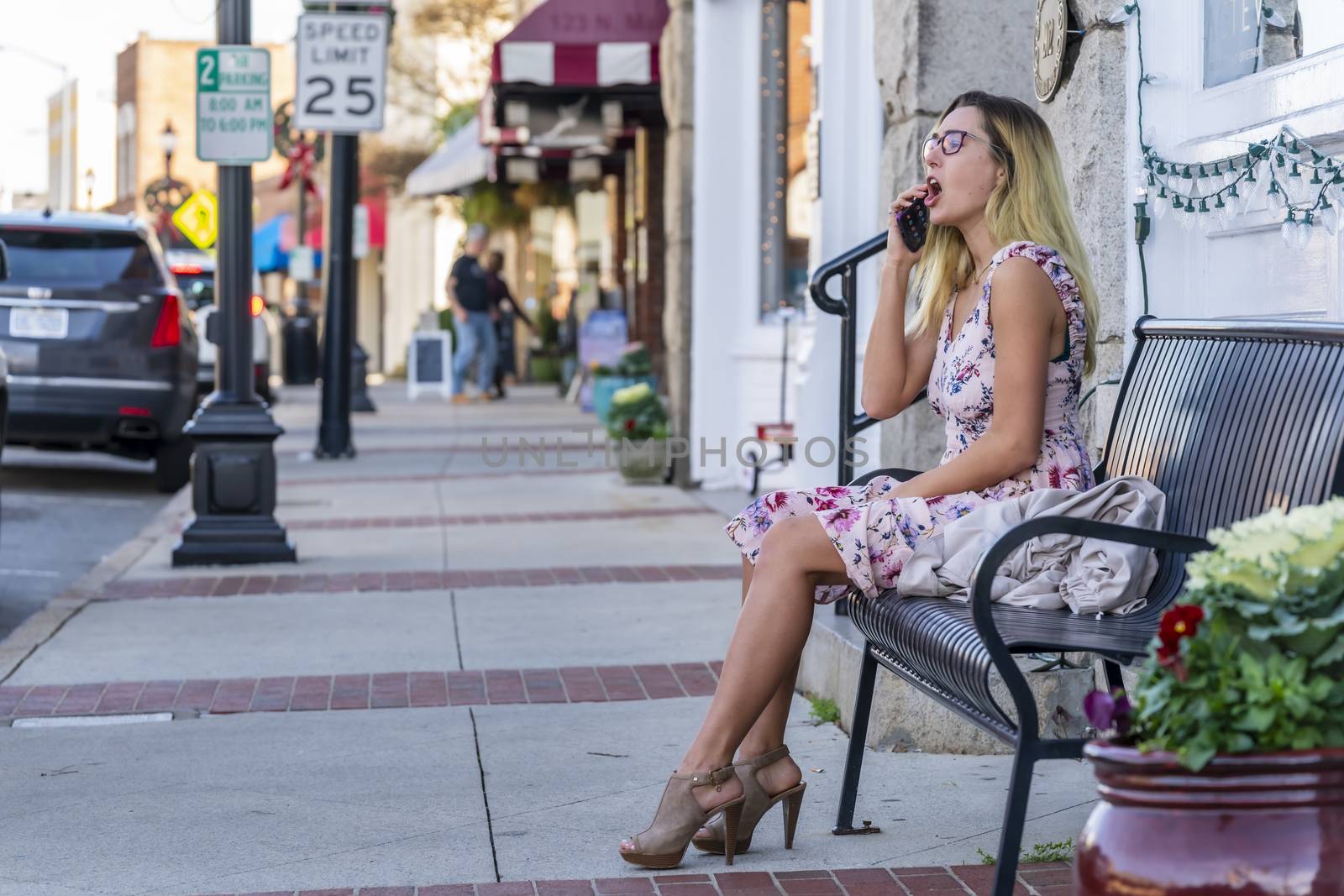 A gorgeous blonde model enjoys a summers day outdoors in a small town